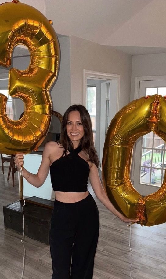 Aleksandra celebrating with gold balloons