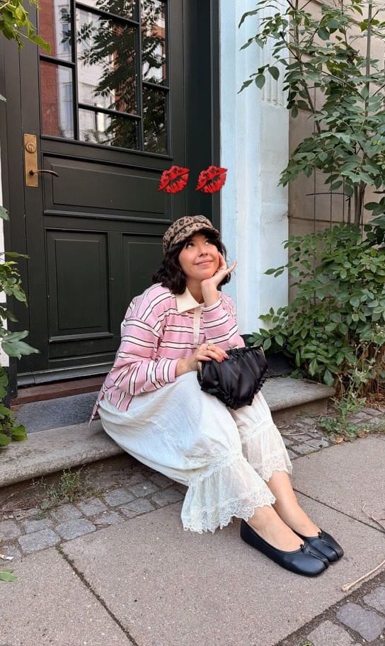Sofia sitting outdoors in a pink shirt
