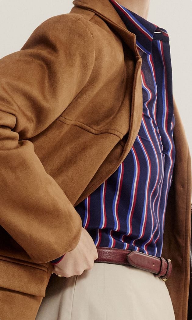 suede jacket over striped shirt